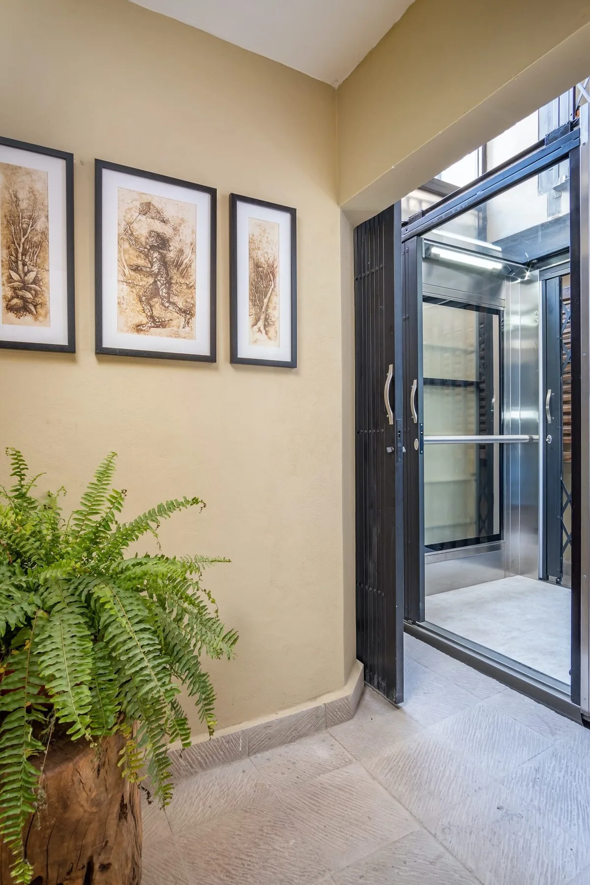Shared amenity: A bright entry area with framed artwork and an open glass doorway.