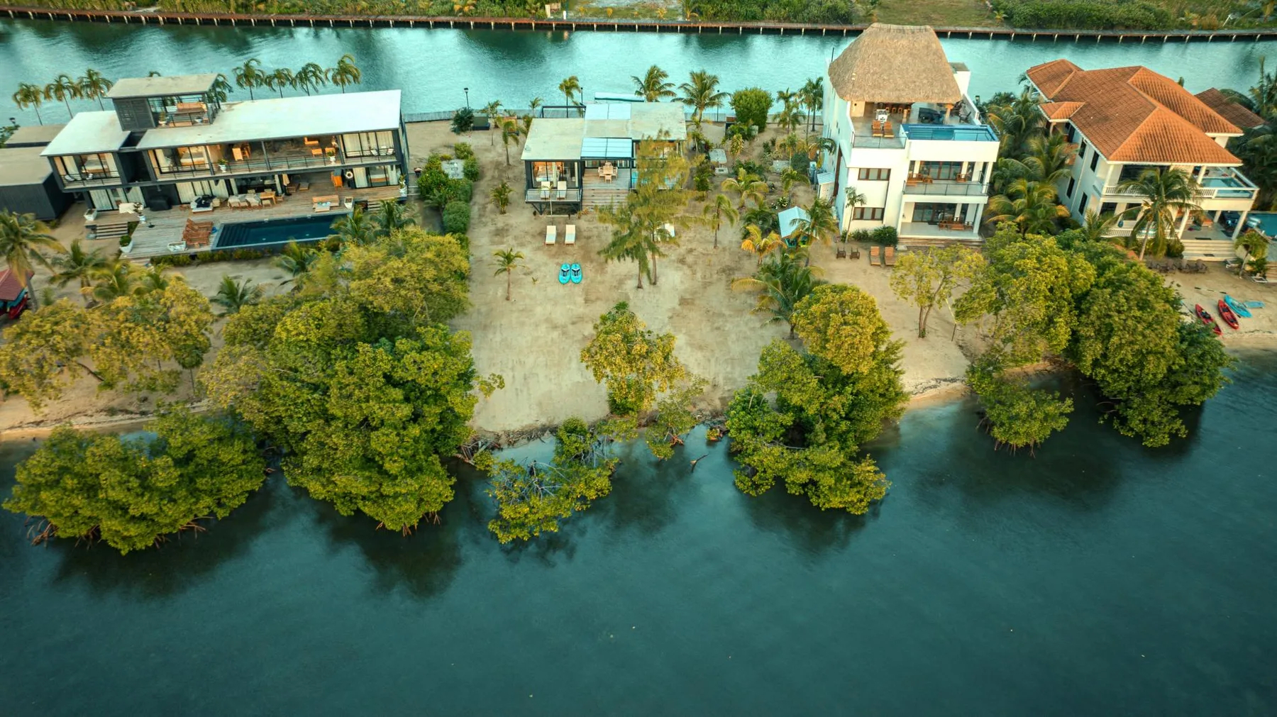 Shared amenity: Aerial view of waterfront buildings surrounded by trees along the water.
