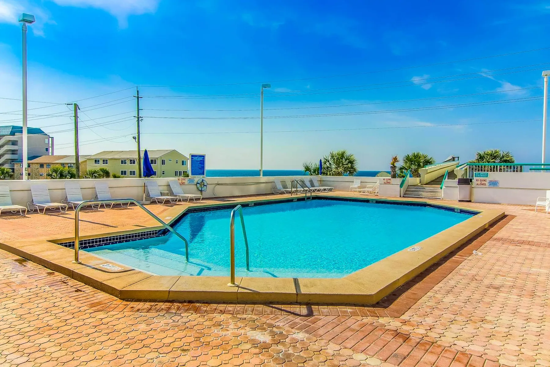 Shared amenity: A rooftop swimming pool is surrounded by lounge seating and a paved deck.