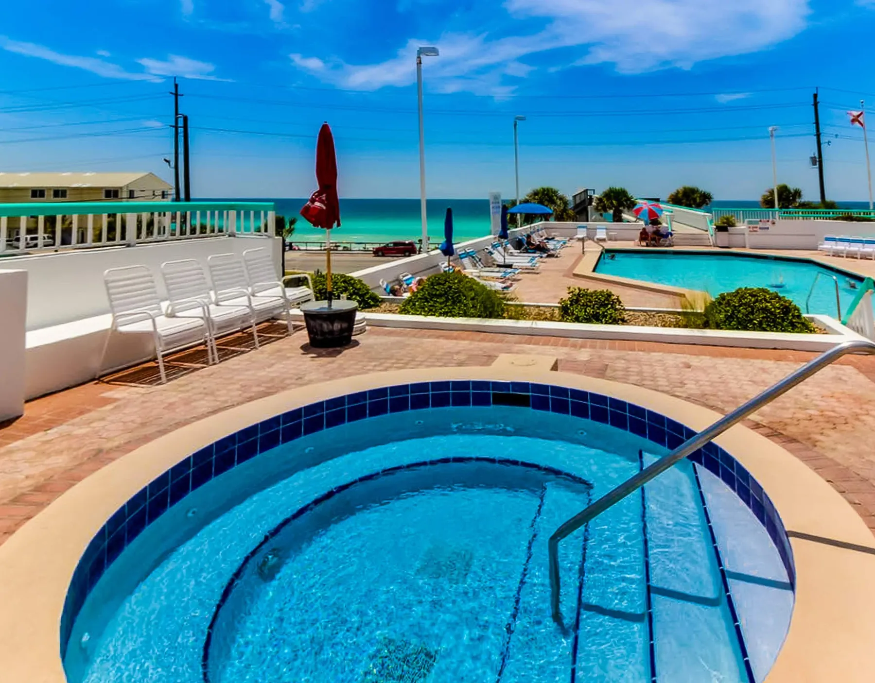 Shared amenity: Outdoor pool area with a circular spa in the foreground.