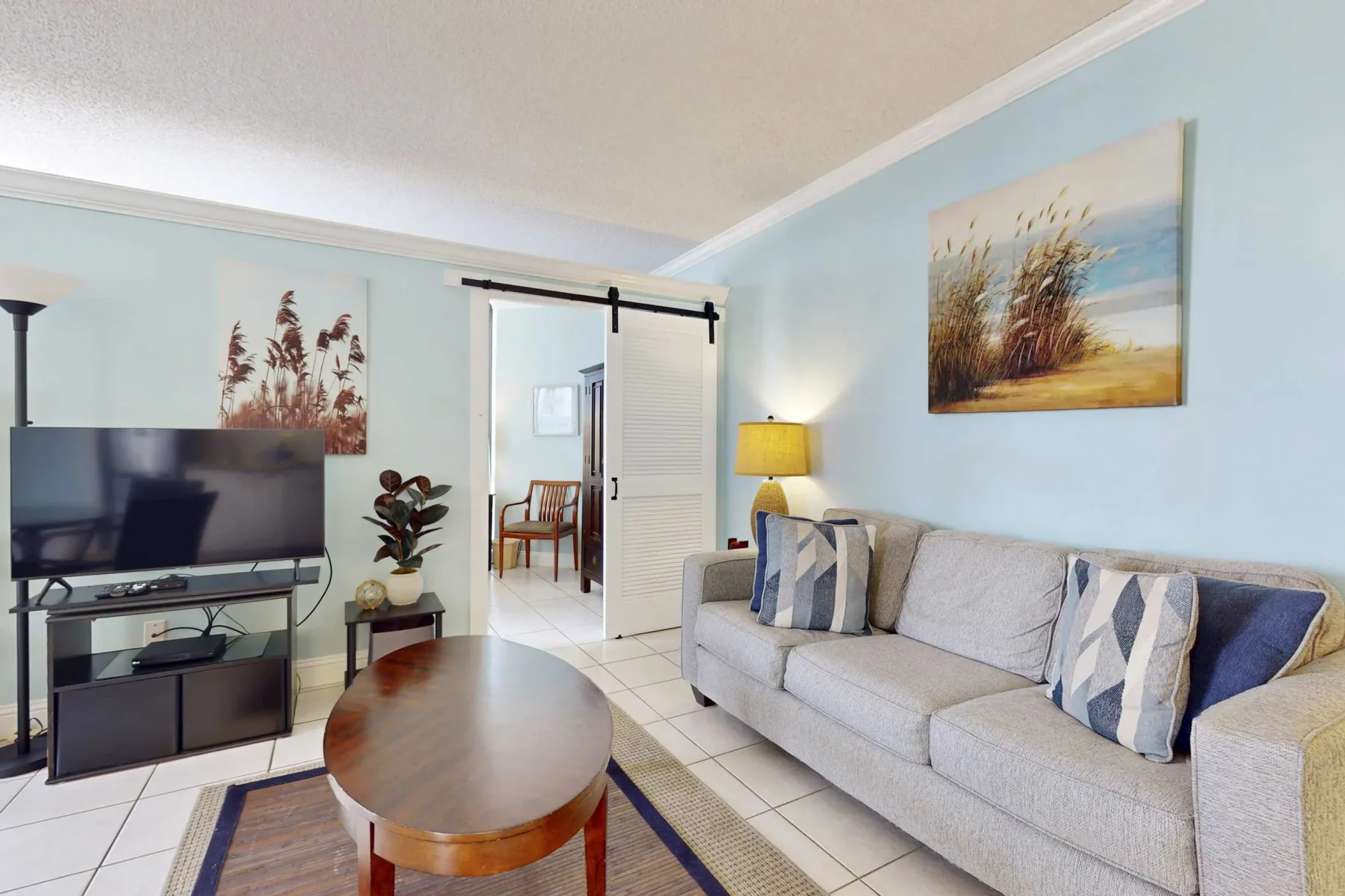 Living room with seating, a television, and a coffee table.