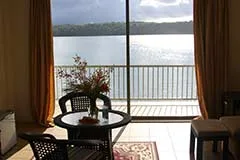 Representative hotel space: A lakeside sitting area with a table and chairs beside a large window.