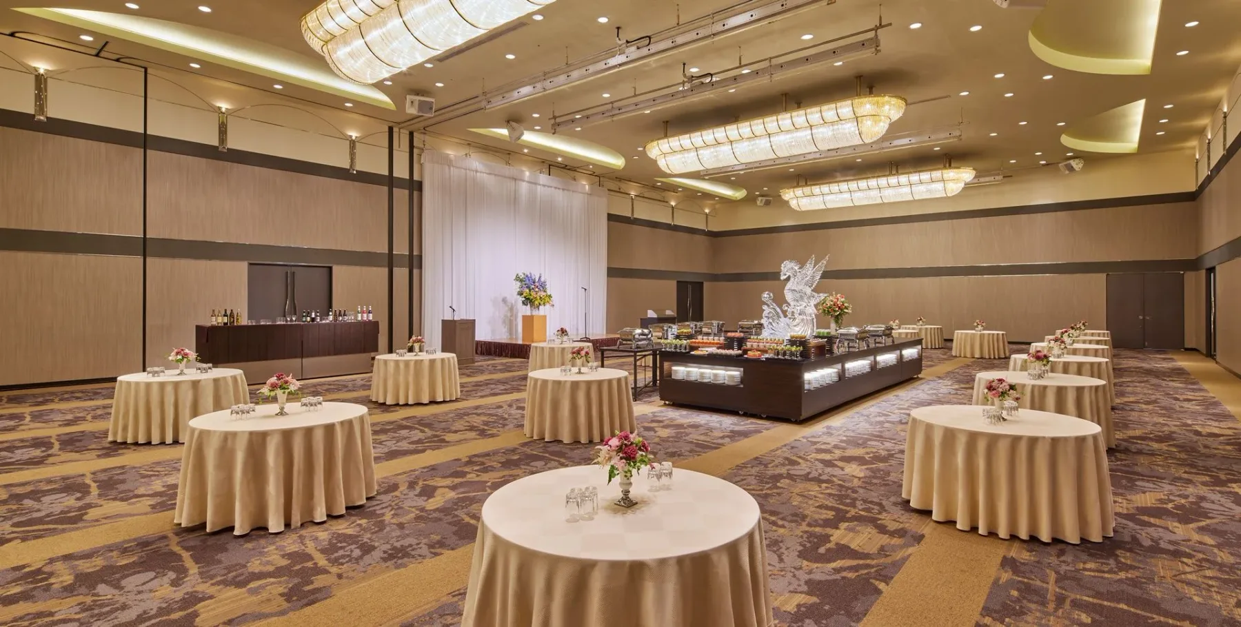 Representative hotel space: A banquet hall with round tables and a buffet display.