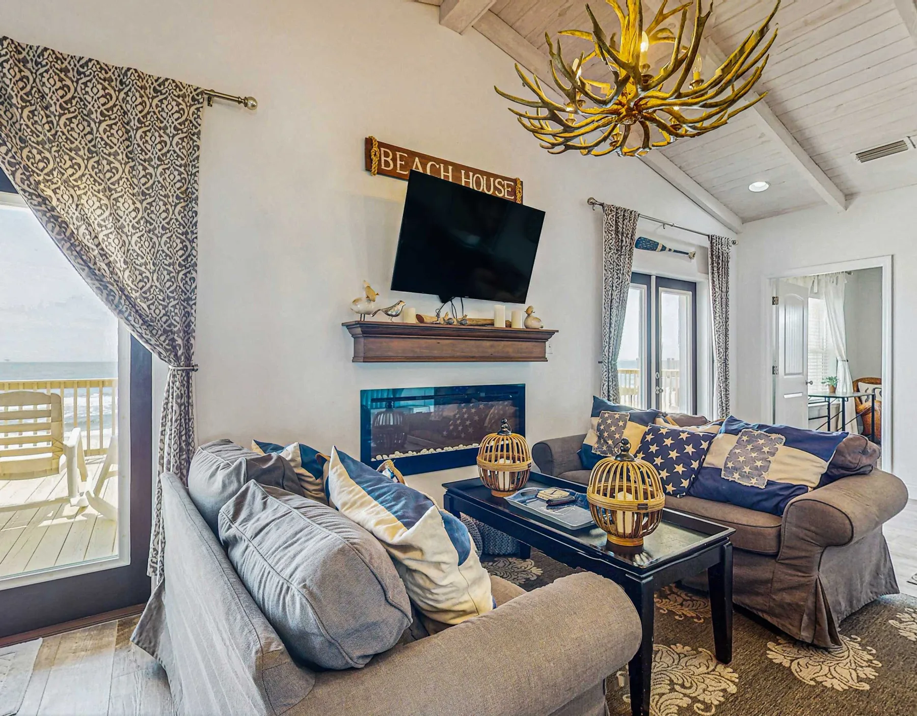 A living room with sofas arranged around a coffee table and fireplace.