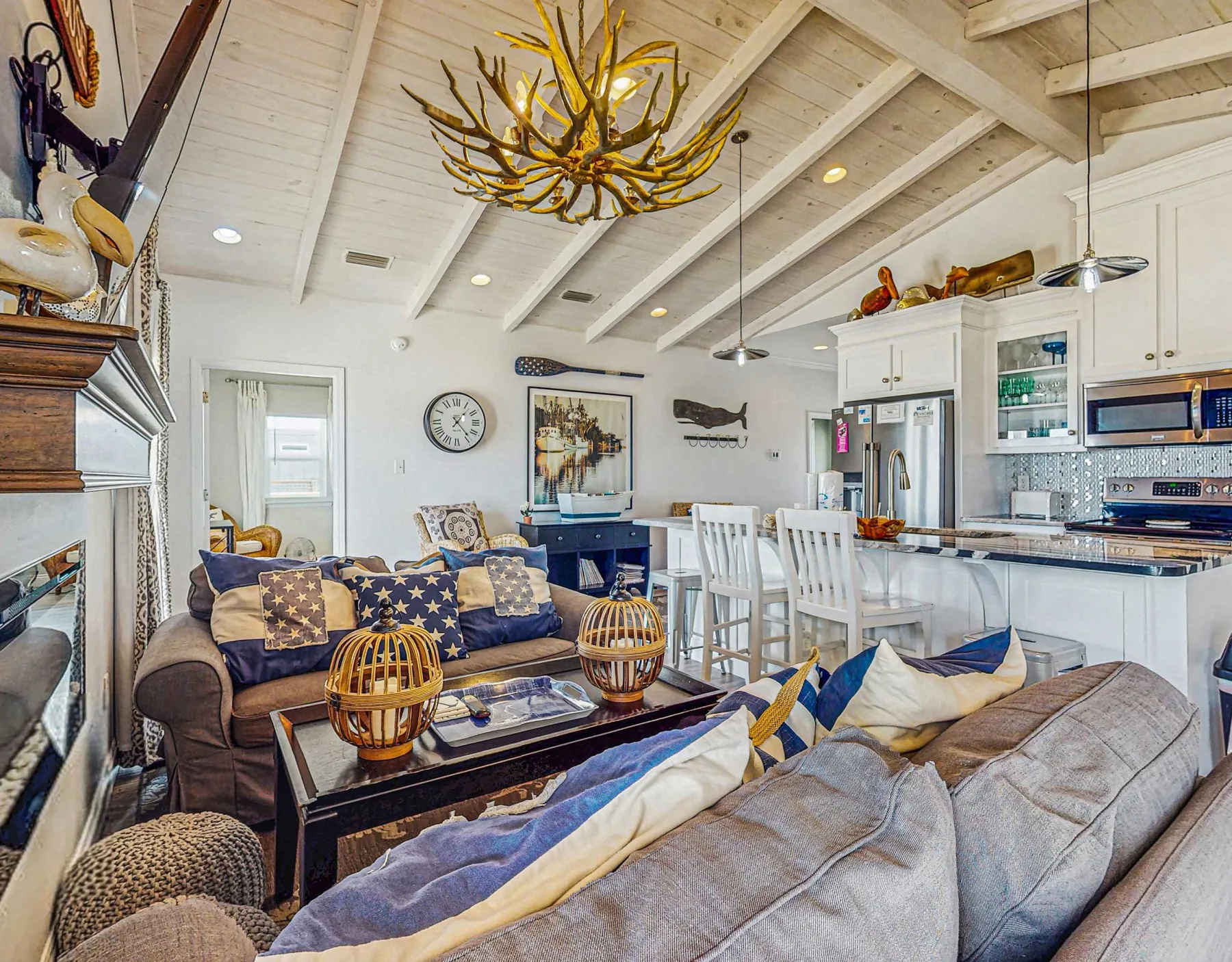 An open-plan living room and kitchen with seating around a coffee table.