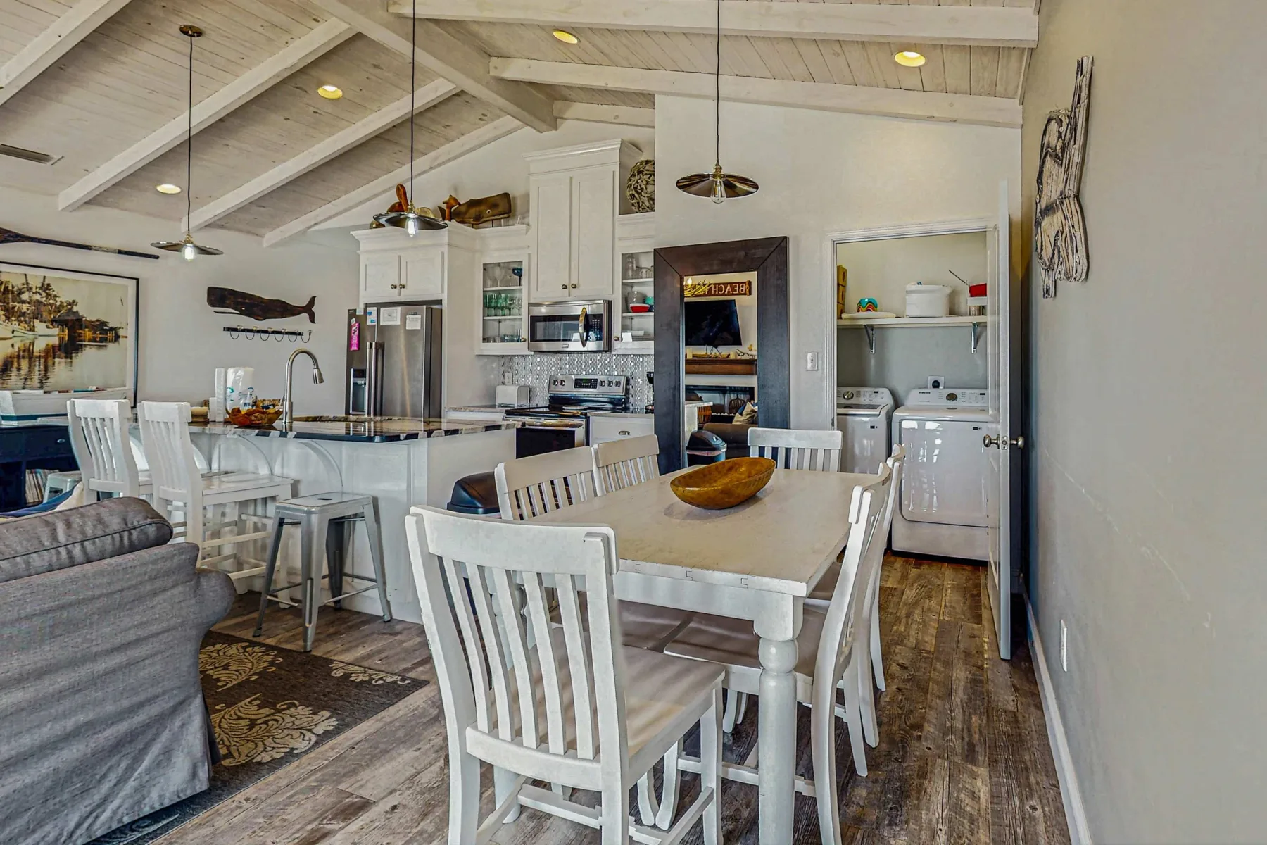 An open kitchen and dining area with a white table and chairs.