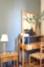 Representative hotel space: A bedroom with a bed, bedside table, and lamp.