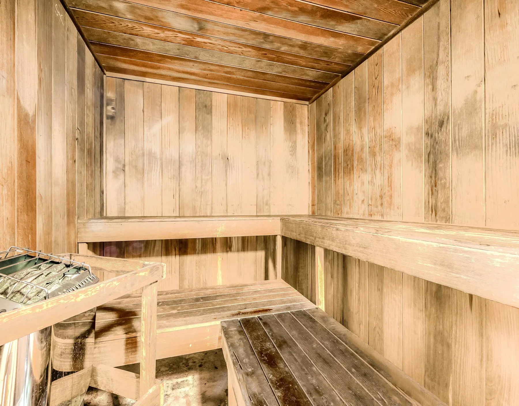 Zona común: Una sauna de madera con bancos escalonados.
