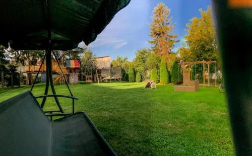 Representative hotel space: A grassy outdoor play area with swings and a small play structure.