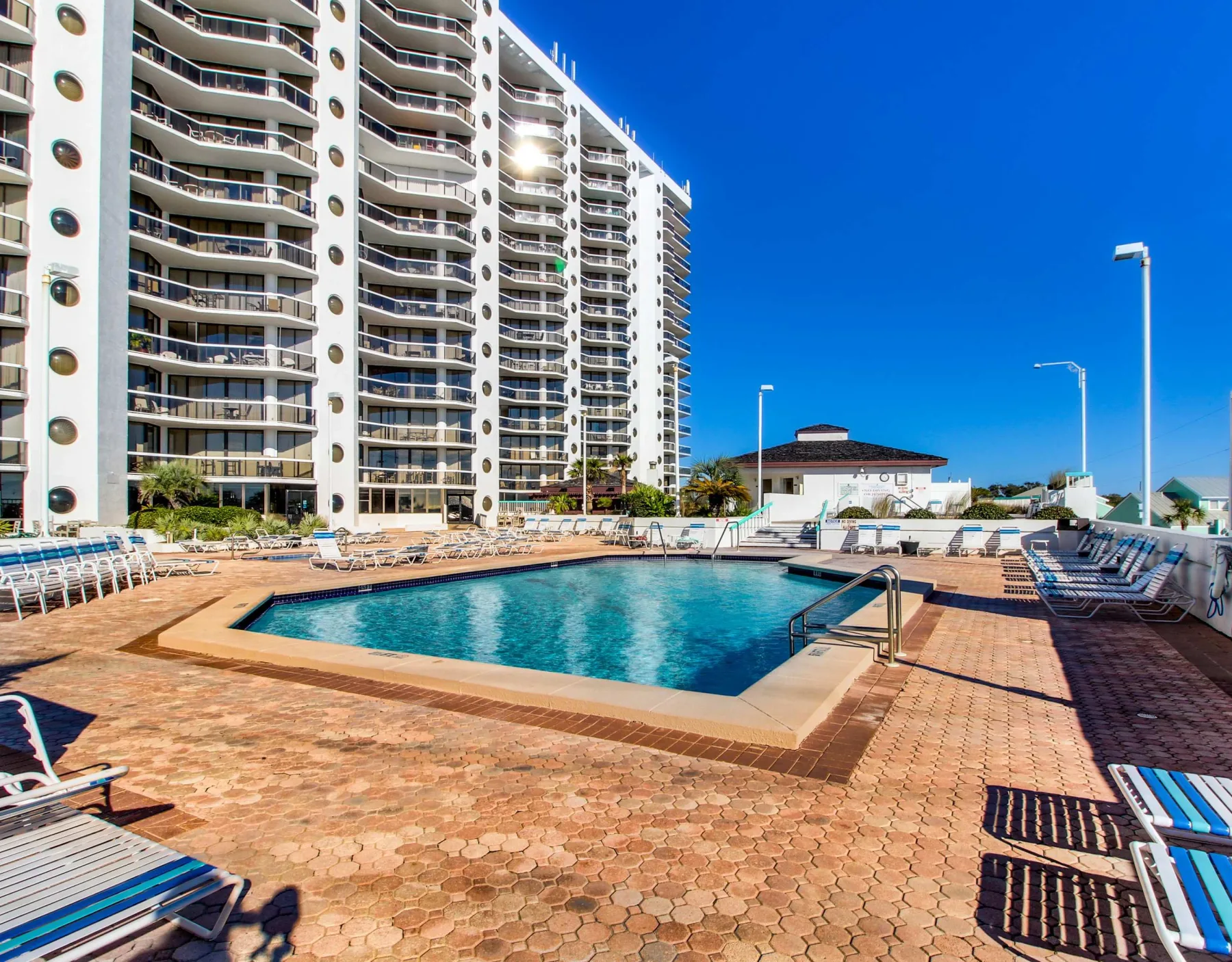 Shared amenity: An outdoor pool sits on a paved deck beside a high-rise building.