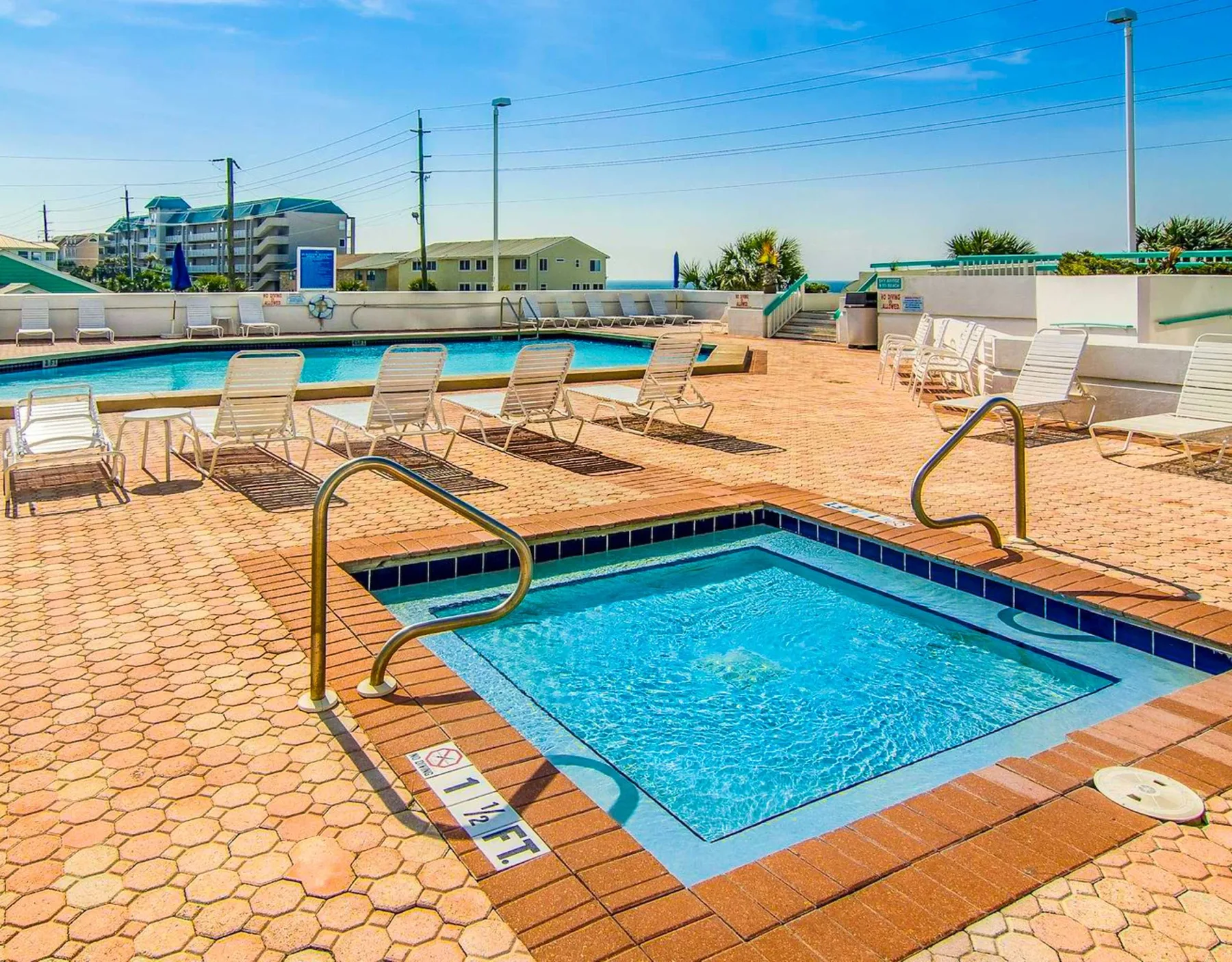 Shared amenity: A rooftop pool area with lounge seating and a smaller pool in the foreground.