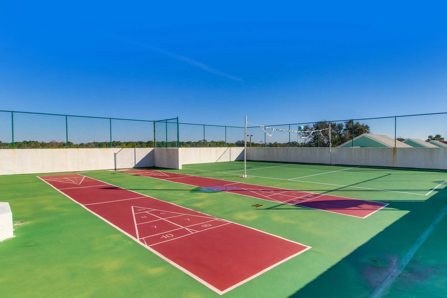 Shared amenity: Outdoor sports court with red and green playing surfaces.