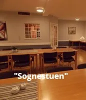 Representative hotel space: A warmly lit dining area has tables, chairs, and a long counter.