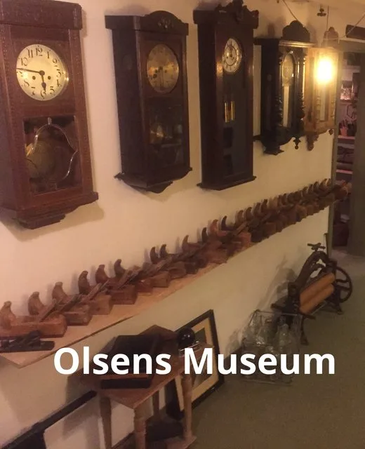 Representative hotel space: A museum display of antique clocks and wooden tools along a wall.