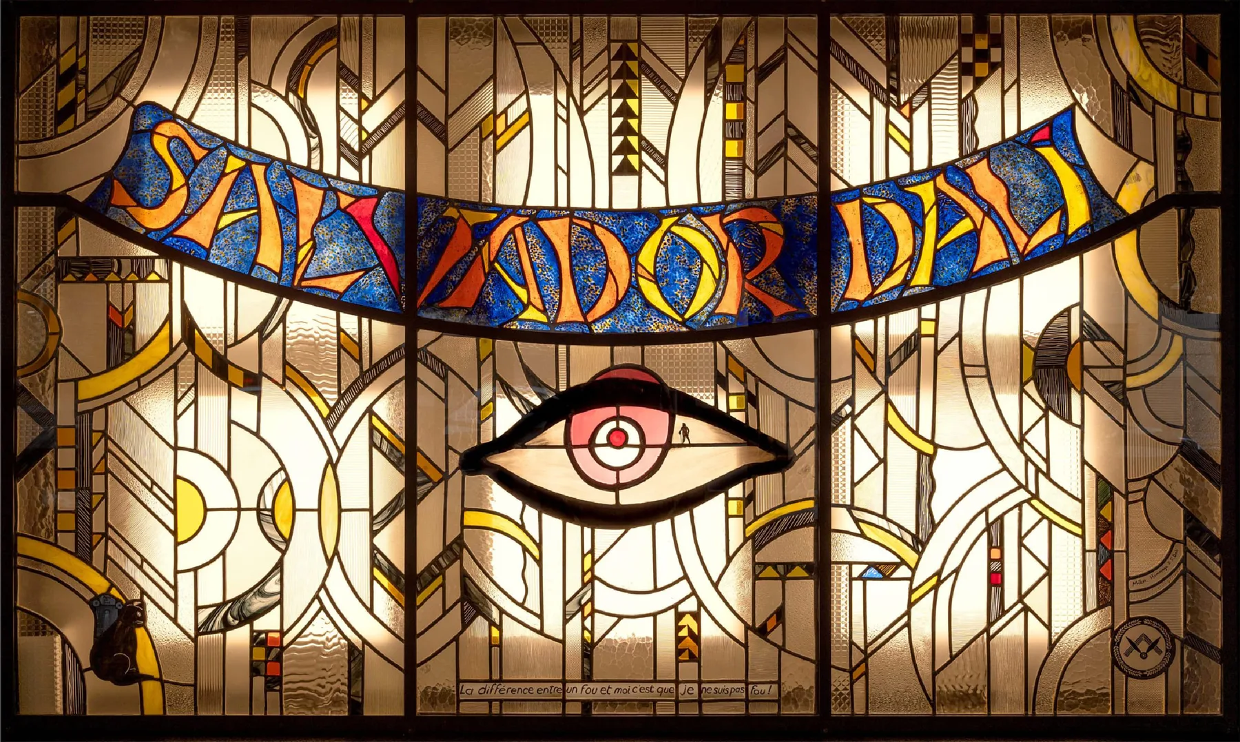 Representative hotel space: A stained-glass window displays a stylized eye beneath a colorful banner.