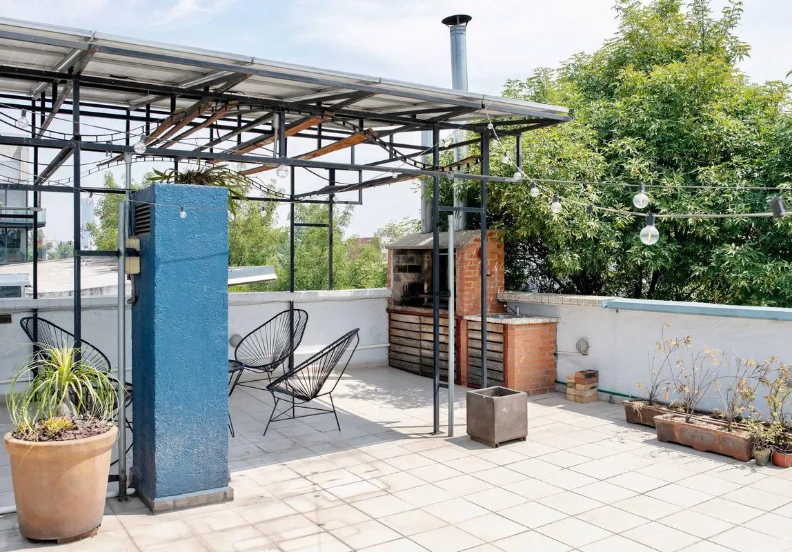 Shared amenity: A rooftop terrace with outdoor seating and a brick barbecue area.