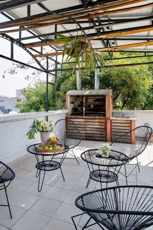 Shared amenity: A rooftop patio with a brick barbecue and outdoor seating.
