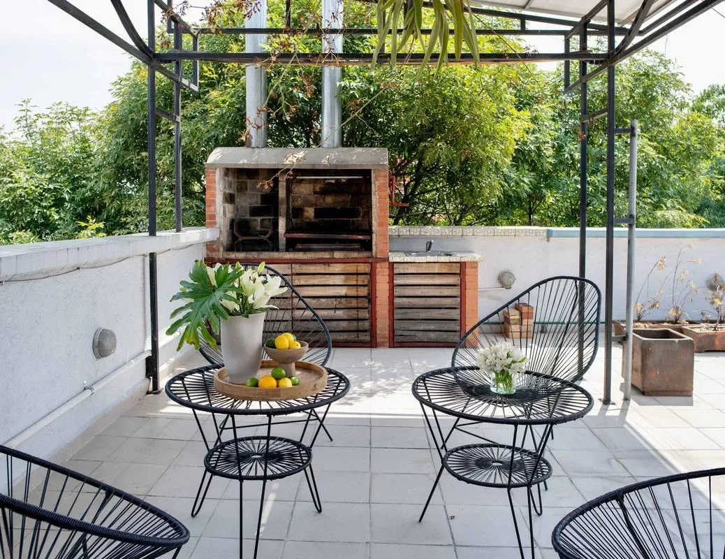 Shared amenity: A rooftop patio with a brick barbecue and outdoor seating.