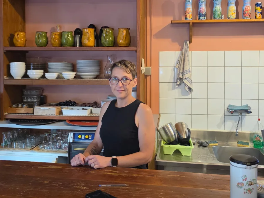 Representative hotel space: A person stands behind a counter in a small café kitchen.