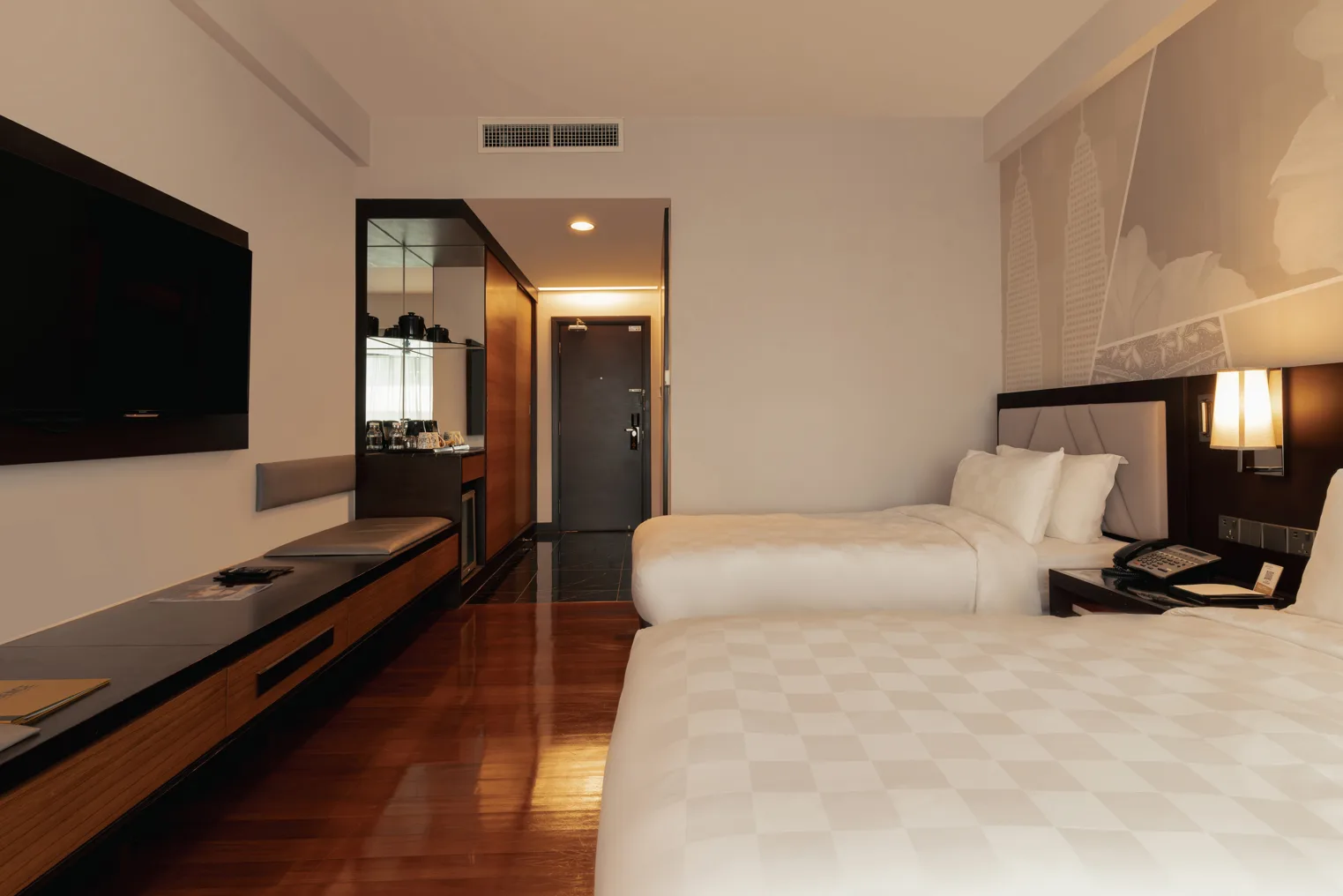 Representative hotel space: A hotel bedroom with two beds, a television, and a desk.