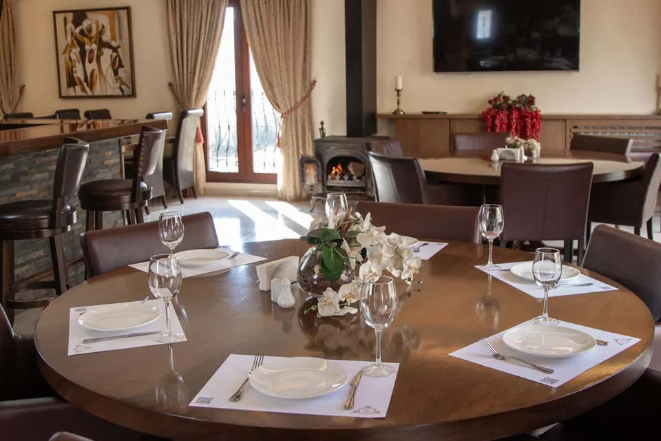 Representative hotel space: Dining room with set tables and a fireplace.