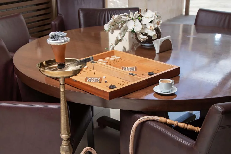 Representative hotel space: A lounge seating area with a wooden game board and a small cup on the table.