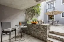 Shared amenity: Outdoor patio with a stone counter, seating, and potted greenery.