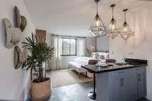 An open living and dining area with a kitchen island and chandelier.