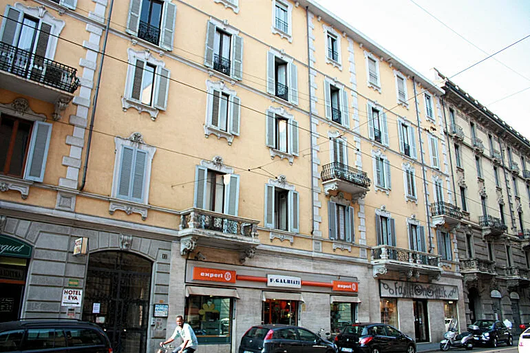 Representative hotel space: Street view of a multi-story building with shops at street level.