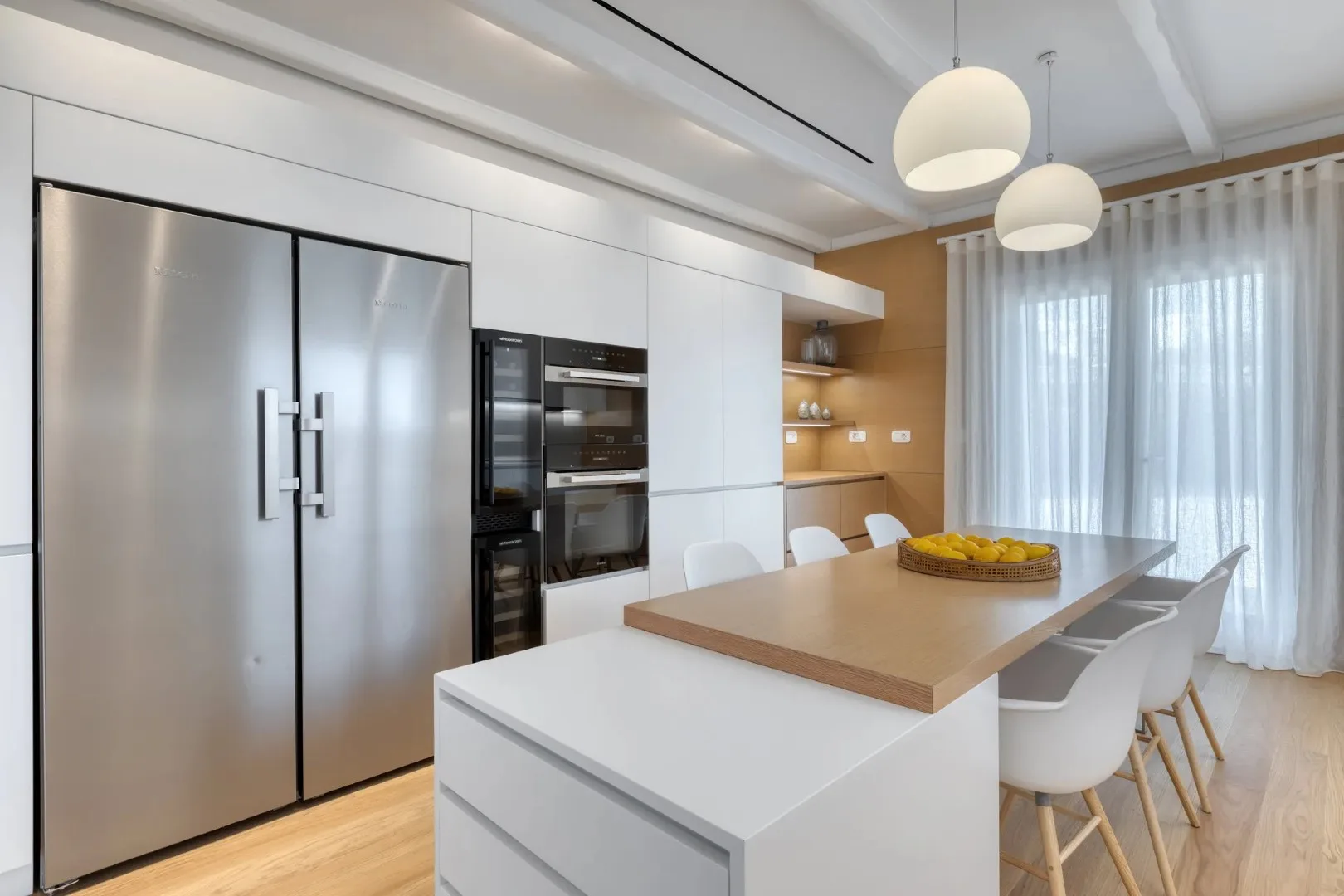 A modern kitchen with a large island and stainless steel appliances.