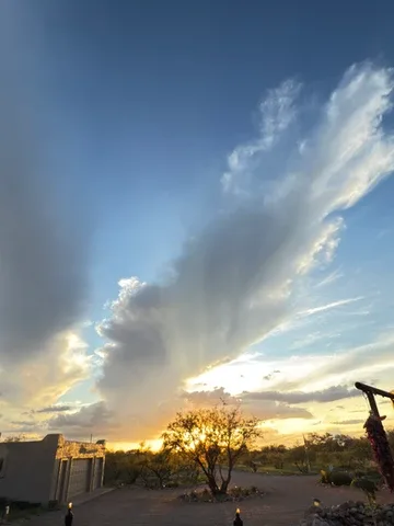 Representative hotel space: A dramatic cloud formation stretches across the sky above a desert landscape.