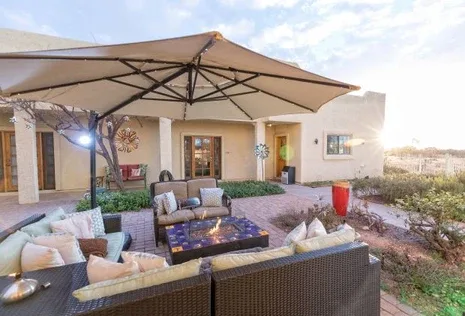 Representative hotel space: An outdoor patio seating area beneath a large shade umbrella.