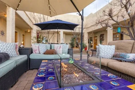 Representative hotel space: An outdoor courtyard seating area surrounds a table beneath large umbrellas.