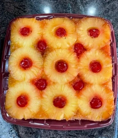 Representative hotel space: A tray of pineapple slices topped with red cherries rests on a countertop.