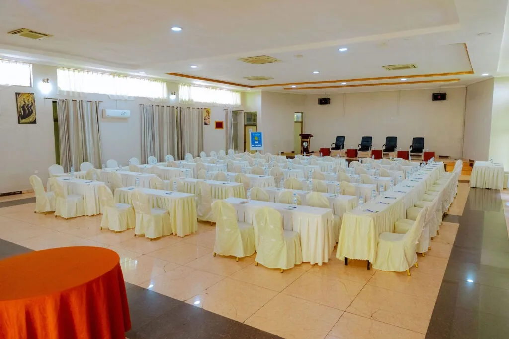 Representative hotel space: A banquet hall is arranged with rows of tables and chairs for an event.