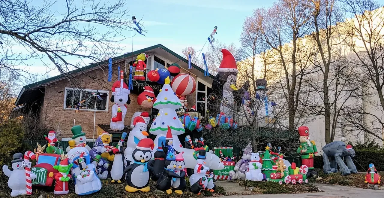 Representative hotel space: A house exterior decorated with inflatable holiday figures and colorful decorations.