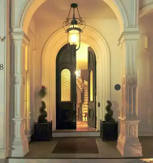 Representative hotel space: An arched entrance with an open doorway and hanging lantern.