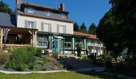 Representative hotel space: A hotel building with a landscaped garden and outdoor seating.