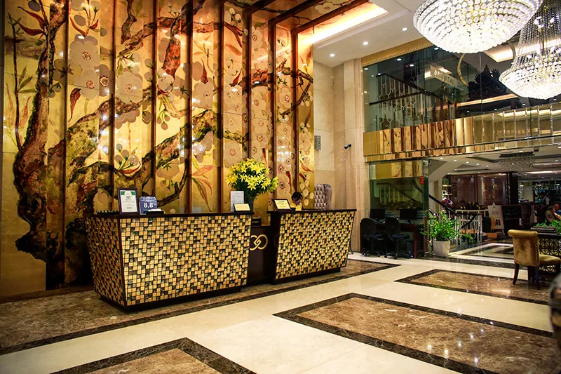 Representative hotel space: Hotel lobby with a patterned reception desk and decorative wall panels.