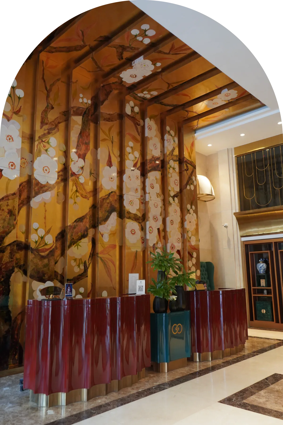 Representative hotel space: Hotel lobby with a floral mural and a long reception desk.
