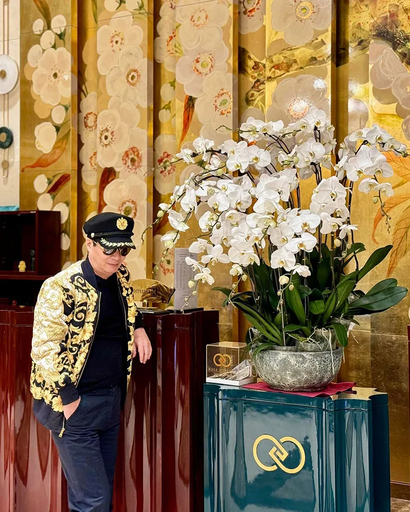 Representative hotel space: A hotel lobby features a large orchid arrangement beside a decorative counter.