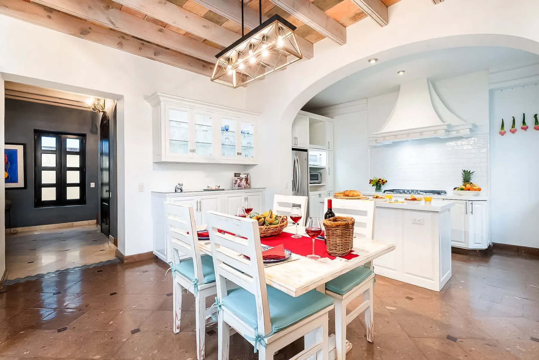 An open kitchen and dining area with a table set for a meal.