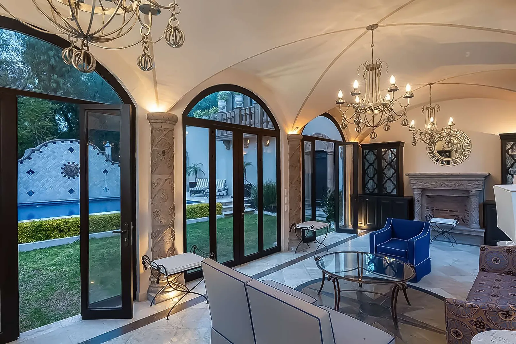Shared amenity: An elegant living room with arched glass doors opening onto a garden.