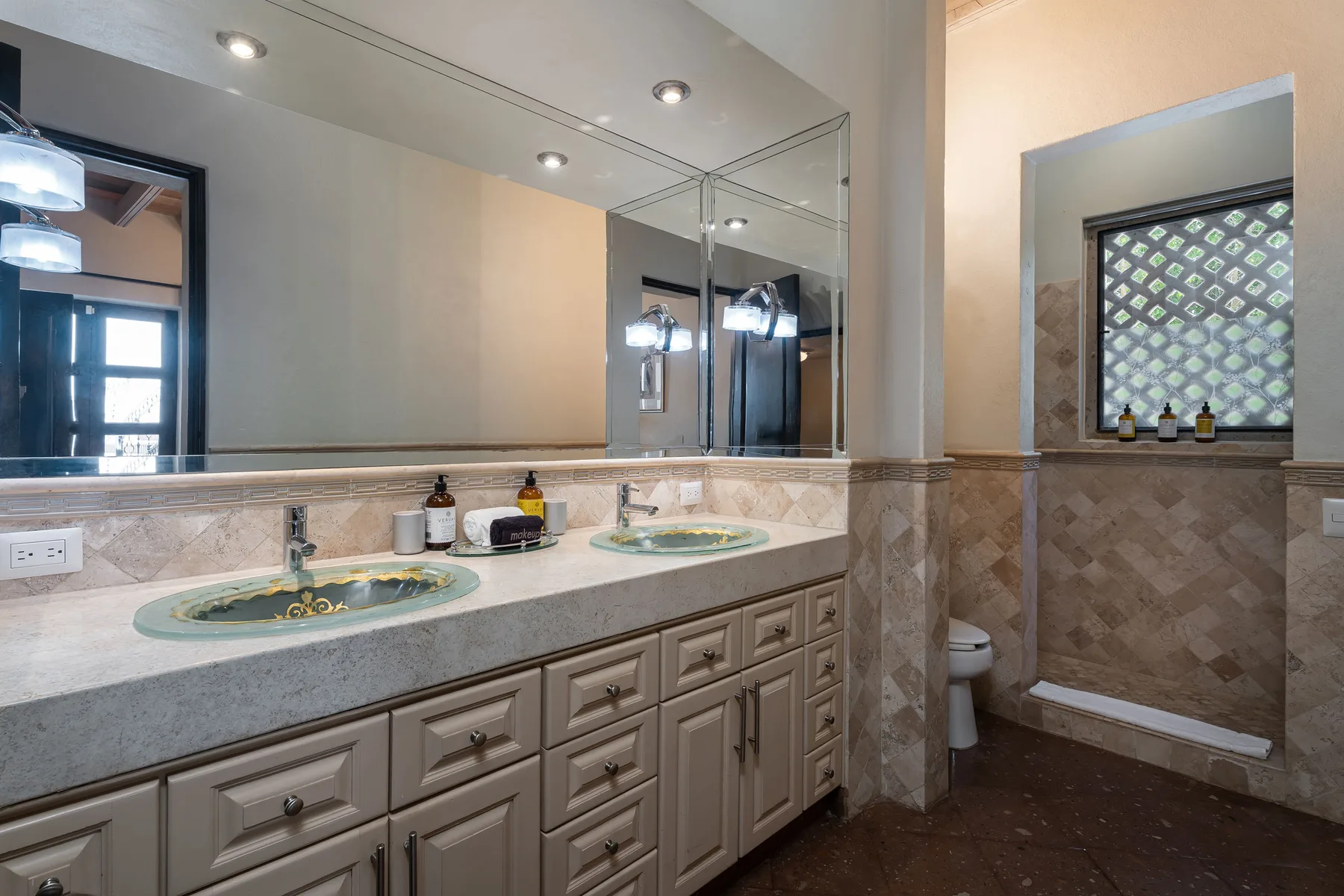A bathroom vanity with two sinks and a large wall mirror.