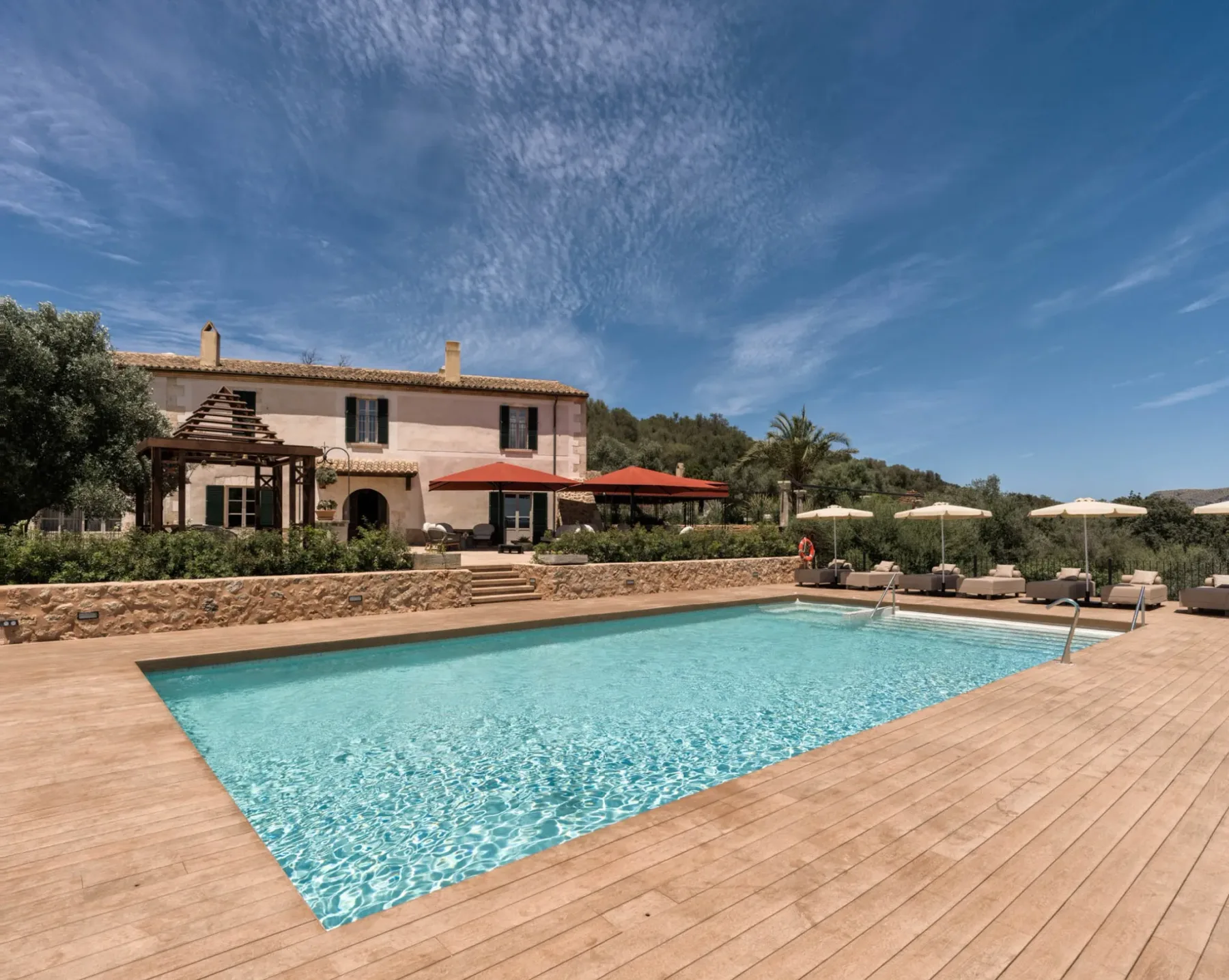 Representative hotel space: An outdoor swimming pool sits beside a building and a deck.