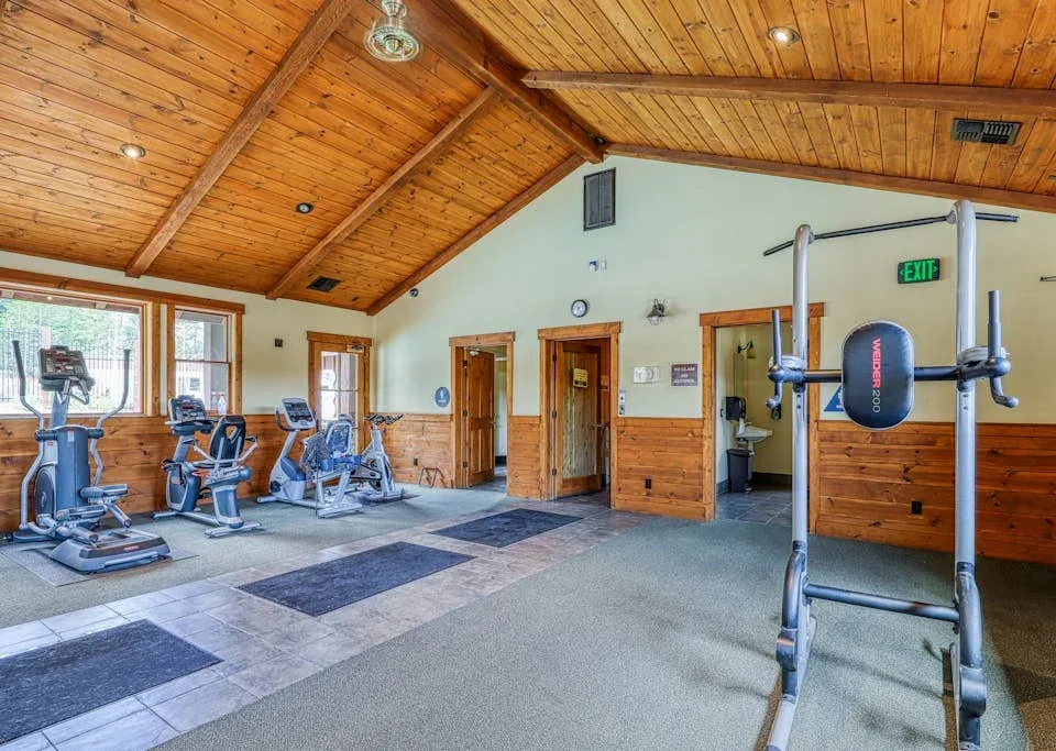 Shared amenity: A fitness room with exercise equipment and a wooden ceiling.