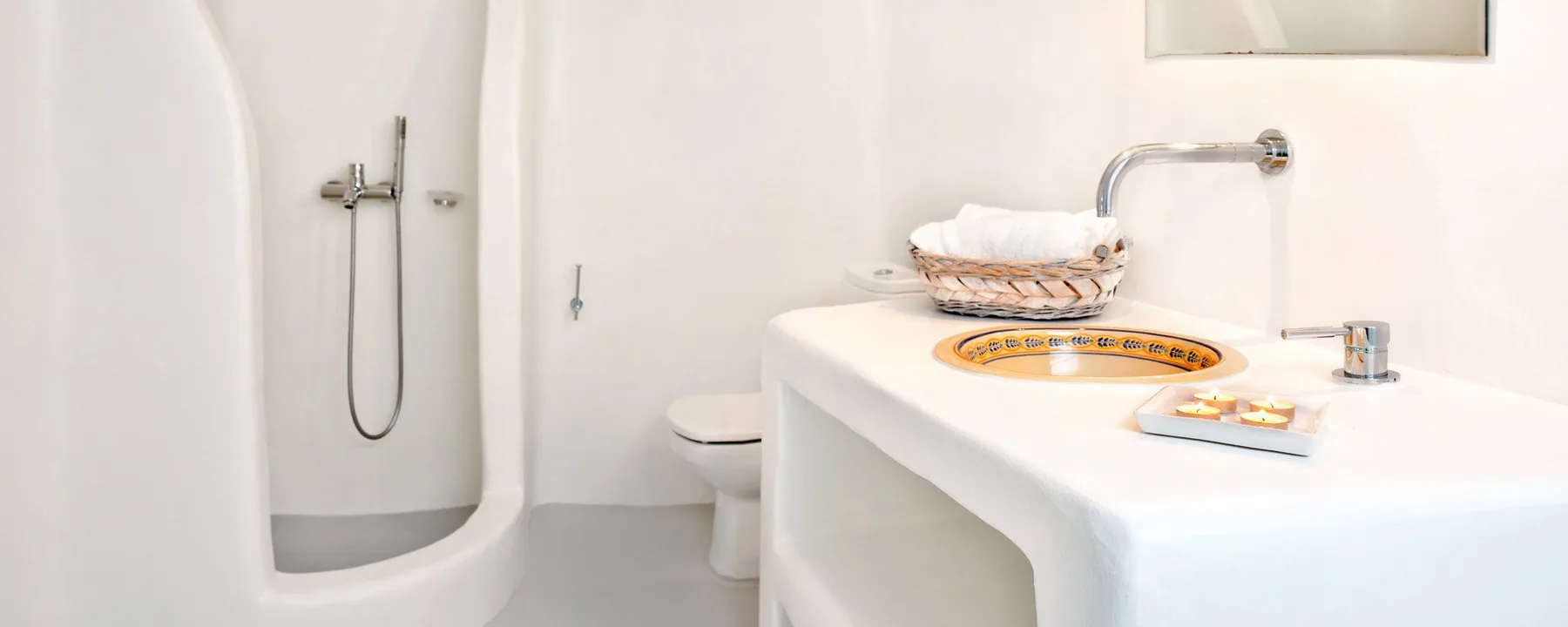 A bright bathroom with a shower, toilet, and sink.