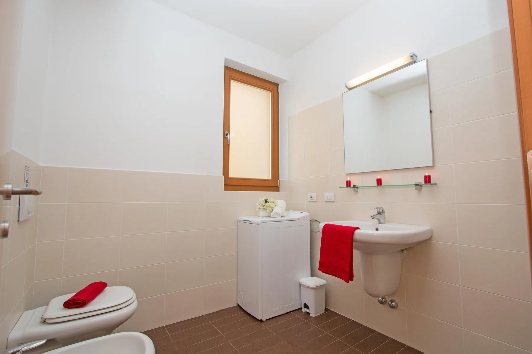 A bathroom with a sink, mirror, and toilet.