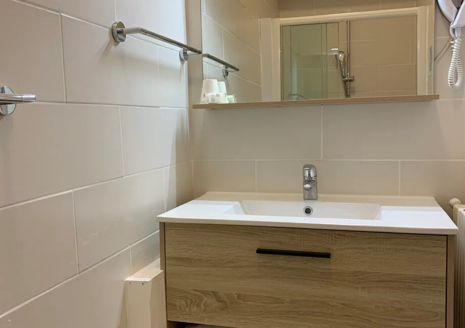 Representative hotel space: Bathroom vanity with a sink beneath a wall mirror.