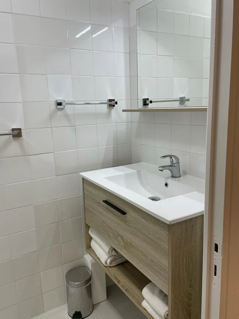 Representative hotel space: A tiled bathroom with a sink and a wall mirror.